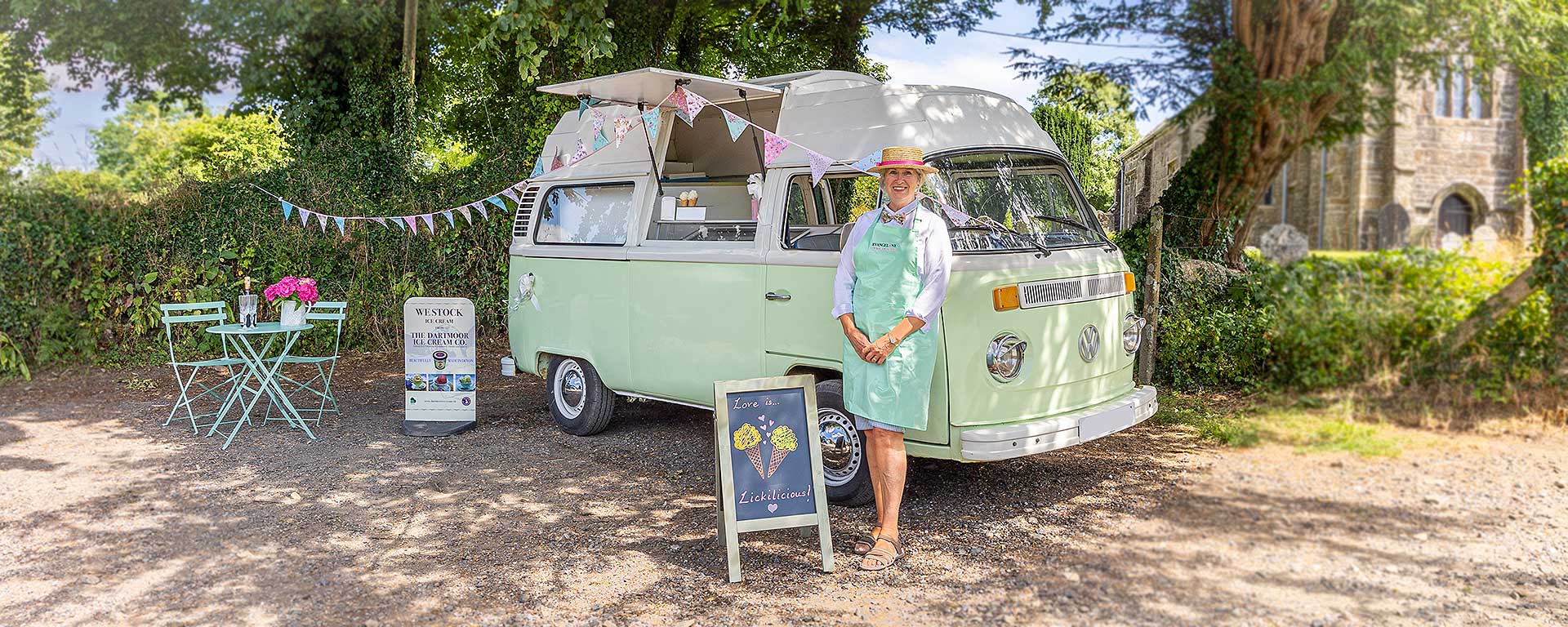 Vintage VW Camper Ice Cream Van beside a church in the sunshine